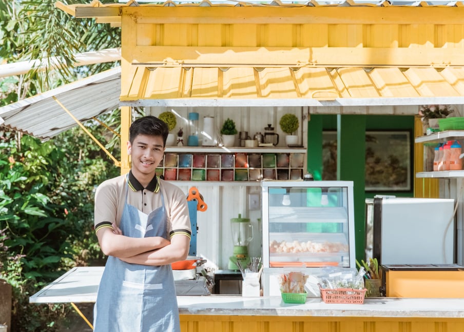 Asian Man Small Business Owner at His Shop Made of Truck Container